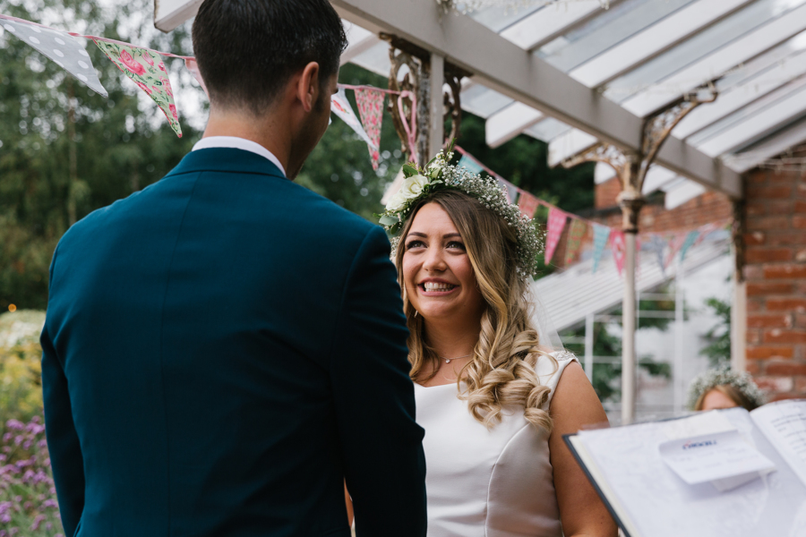 Bride smiles at groom at The Walled Garden Beeston with Emily & Katy Photography