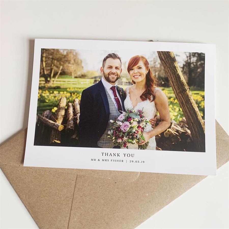Thank you card from wedding couple stood in field of daffodills