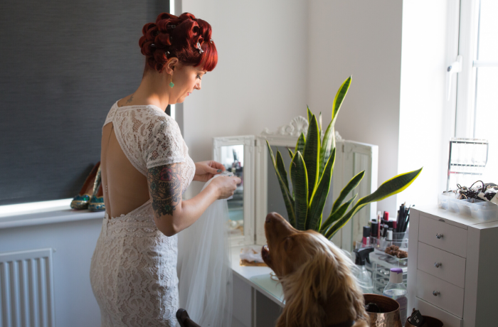Bride getting ready with dog by Shot by Amy