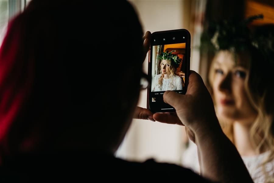 Photo of a photo being taken on a camera phone of a bride to be