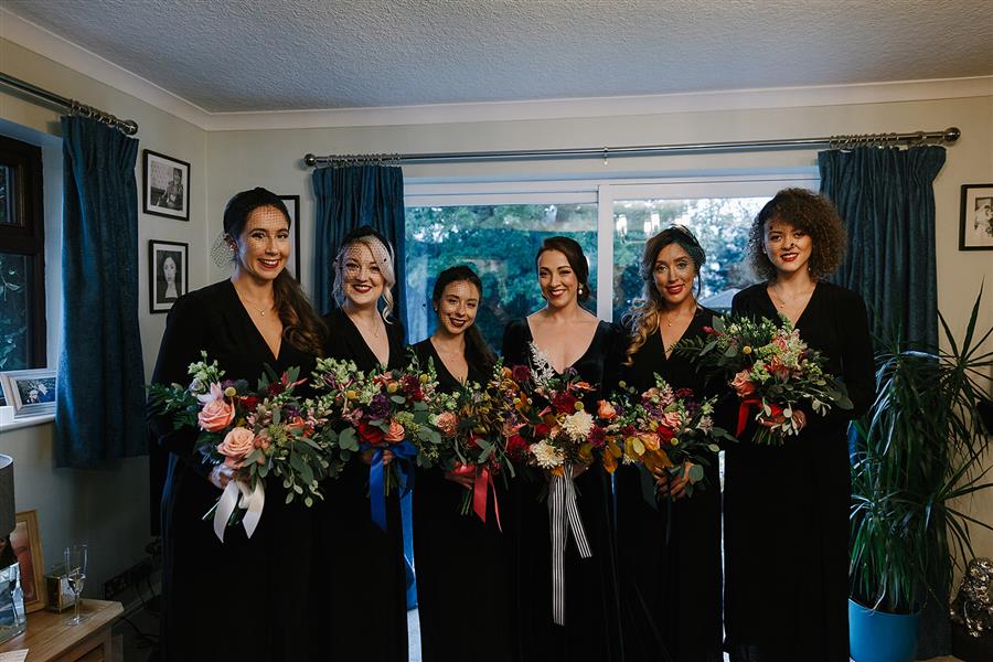 Bride with bridesmaids wearing velvet dresses