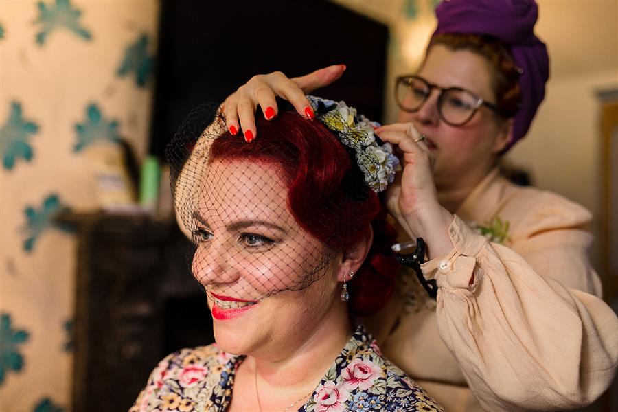 Smiling bride having her hair done by Pin Up Curl