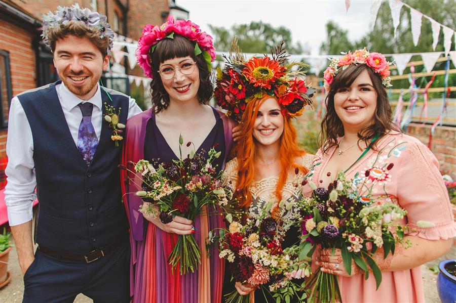 Bride and bridesmaids at alternative wedding with colourful styling