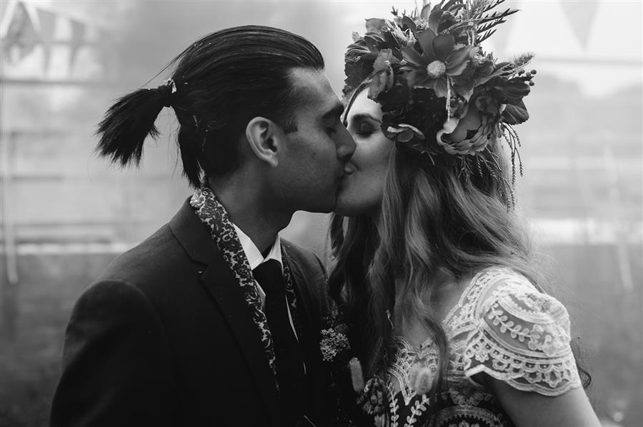 Bride and groom kiss in black and white photo by Camera Hannah