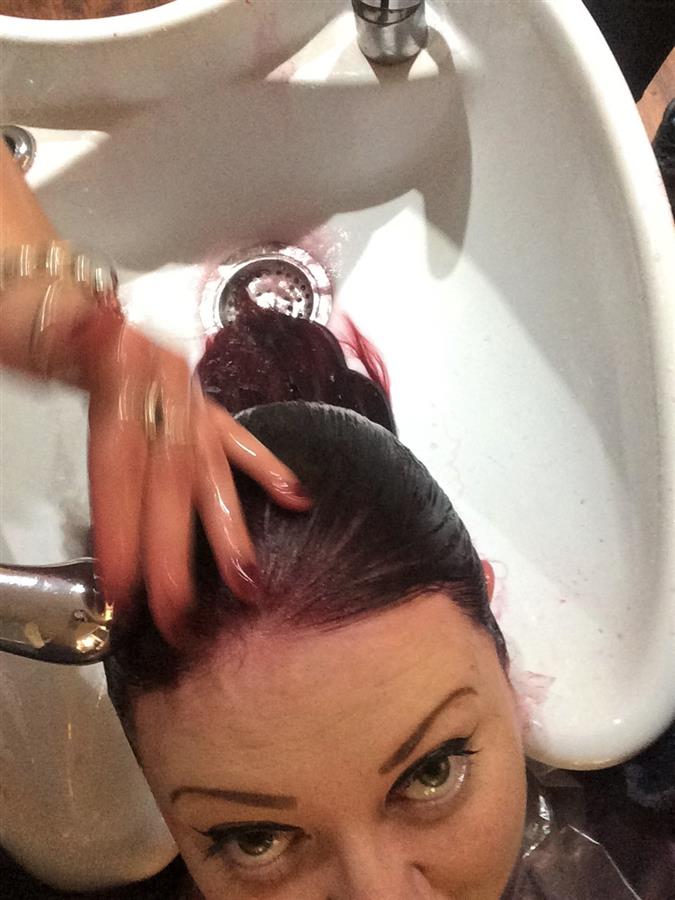 Ms Moo having purple and pink hair dye washed off her hair