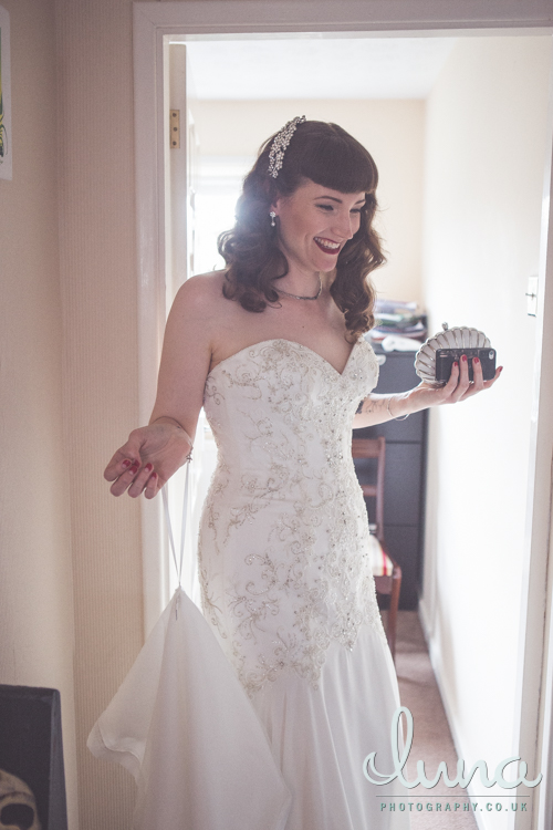 Smiling bride to be with full fringe in white dress
