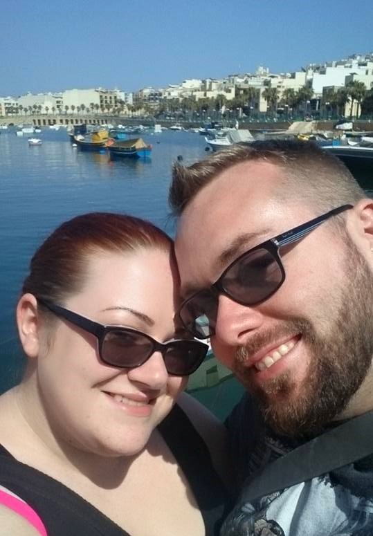 Ms Moo turning 30 on holiday in Malta with Niall in front of a sea harbour with small boats in it