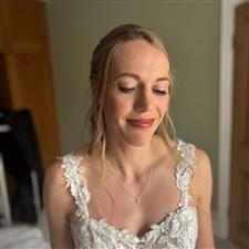 Natural makeup on bride looking at the floor with soft blonde hair
