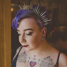 Purple haired bride with spiky alternative headband has smoky eye makeup and dark lip