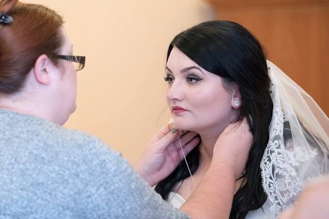 Ms Moo helping a bride get ready on their wedding morning