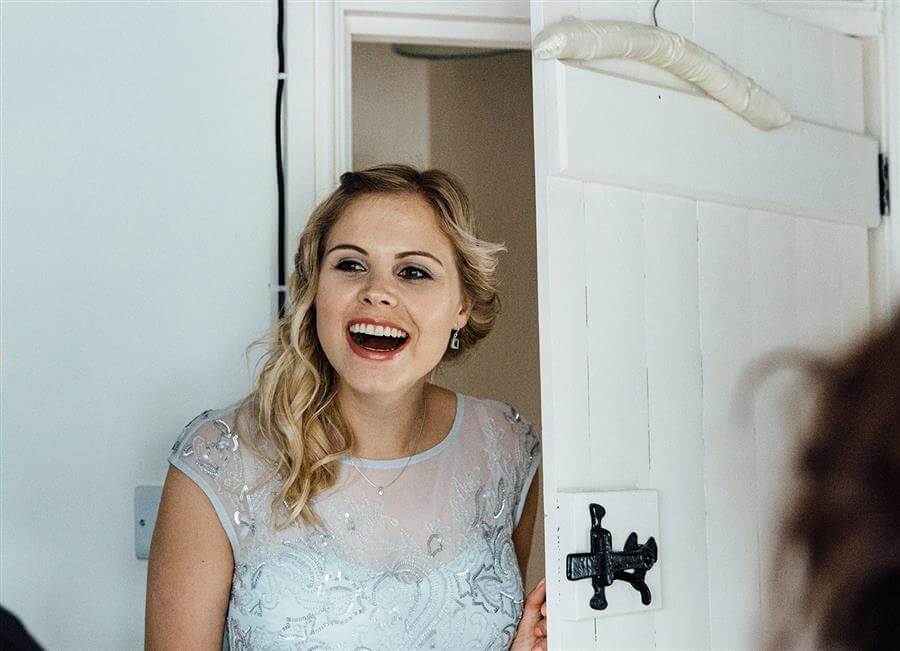 Smiling blonde bridesmaid with makeup by Ms Moo Make Up