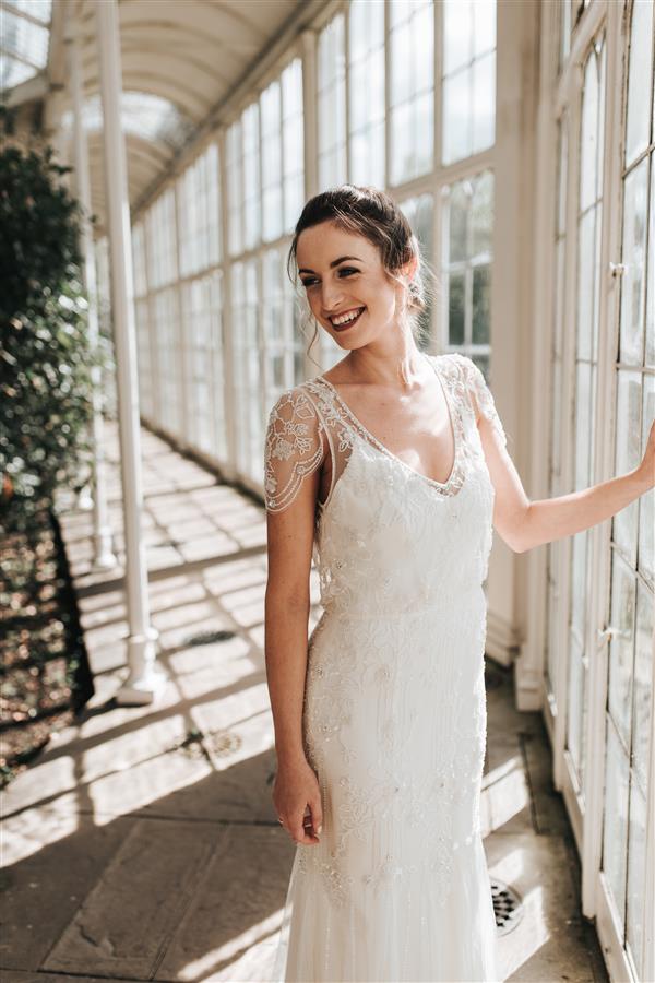 Smiling model at wedding photoshoot wears an elegant white dress
