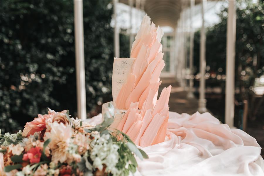 Pale pink shards of icing on elaborate wedding cake