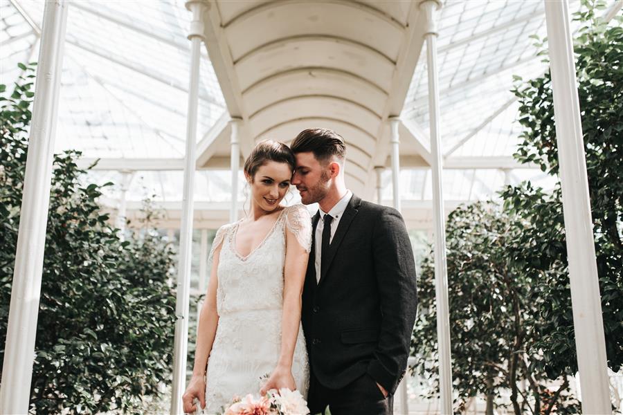 Photo of bride and groom under walk way