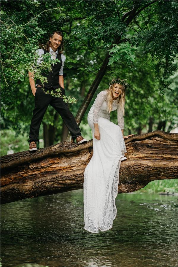 Bride and groom in a tree with happy faces by Ed Godden Photography