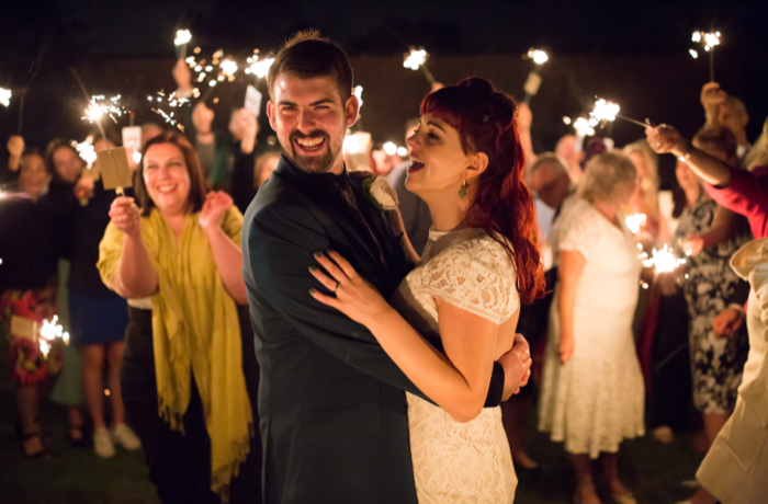 Happy couple with sparkler arch in Elvaston Hall