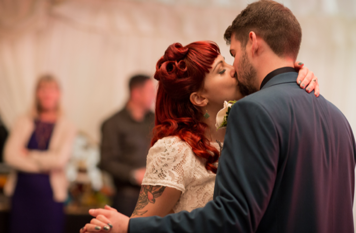 Kissing wedding couple having first dance by Shot by Amy