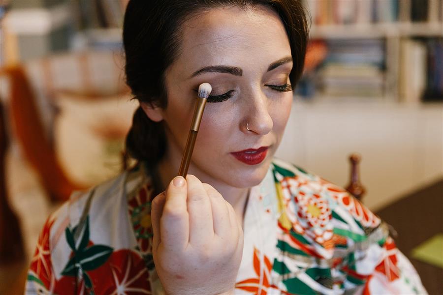 Ms Moo applying cruelty-free makeup to bride