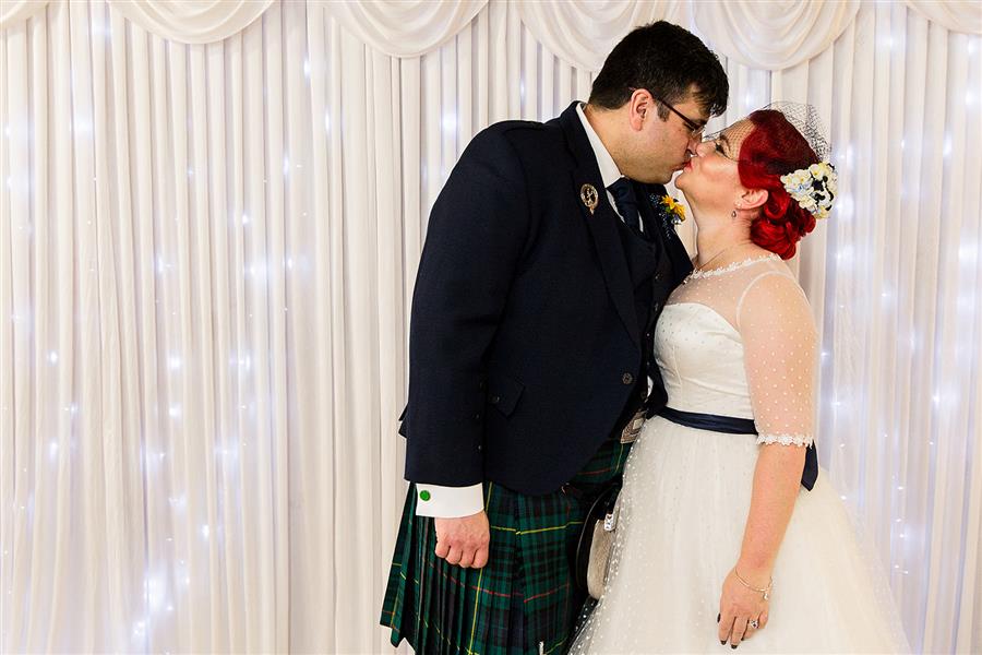 Bride and Groom kissing by Emily & Katy Photography
