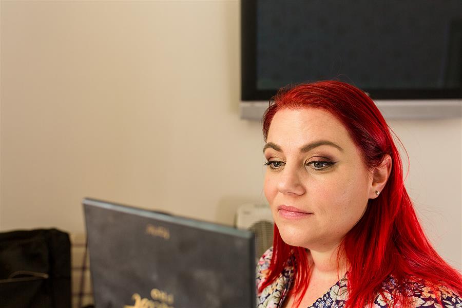 Bride to be checks her wedding makeup in a mirror