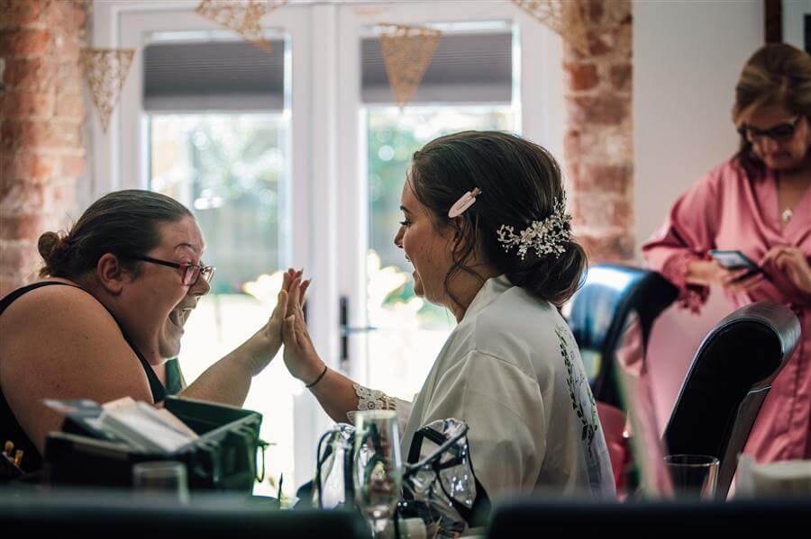 high fiving make up artist