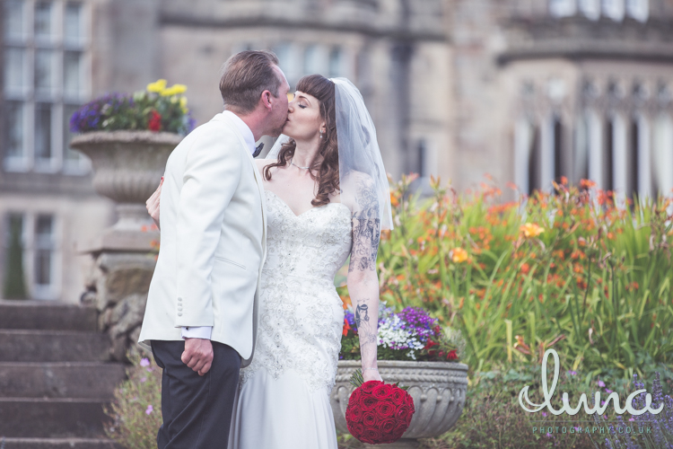 Bride and groom kiss outside Breadsall Priory